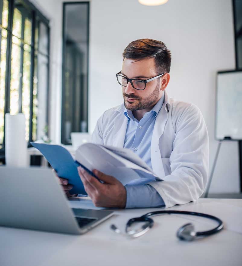 Cardiologist reviewing research publications